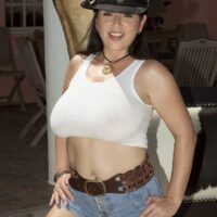 Fabulous brunette Natalie Fiore wets down her funbags while outdoors in a cowgirl hat