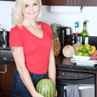 Blonde teen pornstar Madison Hart stands naked in a kitchen