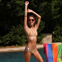 Skinny pornstar Eva Generosi discards her swimwear before toying her cunt and peeing